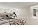 Open living area boasts neutral paint, a comfortable sofa, and an open doorway to another room at 7502 Lush Oasis Ave, Las Vegas, NV 89113