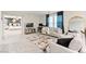 Open living room with neutral decor, a view into the Primary bedroom, and contemporary furnishings at 7502 Lush Oasis Ave, Las Vegas, NV 89113
