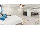 Well-lit bedroom showcasing an open layout with a ceiling fan and convenient access to an adjacent room at 7502 Lush Oasis Ave, Las Vegas, NV 89113