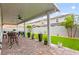 Cozy covered patio with decorative potted plants, brick pavers, and outdoor seating arrangement at 7502 Lush Oasis Ave, Las Vegas, NV 89113