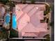 Stunning aerial view of a tile roof home with a sparkling pool and lush landscaping, perfect for luxurious outdoor living at 761 Romano Ln, Henderson, NV 89012