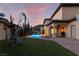 Beautiful backyard featuring a pool, patio seating, lush landscaping and manicured lawn, perfect for entertaining at 761 Romano Ln, Henderson, NV 89012