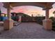 Covered patio with stately columns overlooking a manicured yard with an enclosed pool, offering space to relax at 761 Romano Ln, Henderson, NV 89012