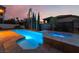 Beautiful backyard with a pool and spa, complete with lush landscaping and a serene setting at 761 Romano Ln, Henderson, NV 89012