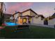 Beautiful backyard featuring a pool, patio seating, lush landscaping and manicured lawn, perfect for outdoor activities at 761 Romano Ln, Henderson, NV 89012