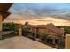 Sunset view from a balcony overlooking neighborhood with mature landscaping at 761 Romano Ln, Henderson, NV 89012