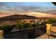 Sunset view from a balcony overlooking the neighborhood with mature landscaping at 761 Romano Ln, Henderson, NV 89012