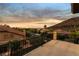 Scenic balcony view of lush landscaping, mountains and desert landscape at sunset at 761 Romano Ln, Henderson, NV 89012