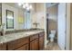Bathroom vanity featuring a granite countertop, a sink, and a view of the toilet and shower at 761 Romano Ln, Henderson, NV 89012