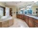 Spacious bathroom featuring a large tub, and an expansive vanity with double sinks at 761 Romano Ln, Henderson, NV 89012