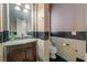 Cozy powder room with elegant marble countertops and decorative mosaic tile accents on the walls at 761 Romano Ln, Henderson, NV 89012