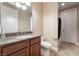 Cozy bathroom featuring granite countertops, wooden cabinetry, and a toilet next to the vanity at 761 Romano Ln, Henderson, NV 89012