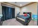 Comfortable bedroom with neutral walls, plush carpeting, and a bed with storage drawers for a cozy retreat at 761 Romano Ln, Henderson, NV 89012