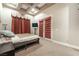 Bedroom featuring tray ceiling, warm lighting, wall-mounted TV and access to balcony at 761 Romano Ln, Henderson, NV 89012