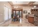 Bright dining area with wet bar, pendant lighting, and access to the backyard at 761 Romano Ln, Henderson, NV 89012