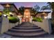 Beautiful home with an arched entryway and steps to the front door, professionally landscaped with manicured shrubs at 761 Romano Ln, Henderson, NV 89012