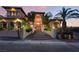 Beautiful home with an arched entryway, steps to the front door, and professionally landscaped front yard at twilight at 761 Romano Ln, Henderson, NV 89012