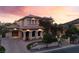Stunning two-story home with a tile roof, arched entryway, and beautifully landscaped front yard at 761 Romano Ln, Henderson, NV 89012