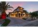 Stunning home with mature palms, tiled roof, arched openings, and circular paved driveway with three-car garage at 761 Romano Ln, Henderson, NV 89012