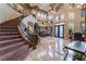 Grand foyer with staircase, chandelier, and high ceilings welcomes you into this luxurious home at 761 Romano Ln, Henderson, NV 89012