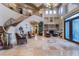 Expansive home foyer with soaring ceilings, grand staircase, and elegant tile flooring at 761 Romano Ln, Henderson, NV 89012