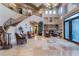 Expansive home foyer with soaring ceilings, grand staircase, and elegant tile flooring at 761 Romano Ln, Henderson, NV 89012
