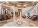 Elegant foyer boasting tile floors, stairs to 2nd floor, chandelier and view of formal dining room at 761 Romano Ln, Henderson, NV 89012