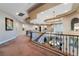 Second-floor hallway with a decorative wrought iron railing and a view of the formal living room below at 761 Romano Ln, Henderson, NV 89012