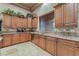 Kitchen featuring granite countertops, stainless appliances, and custom wood cabinets for storage at 761 Romano Ln, Henderson, NV 89012