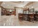 Open-concept kitchen featuring a stone bar, island seating, and stainless steel appliances at 761 Romano Ln, Henderson, NV 89012