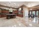 Gourmet kitchen with island, dark wood cabinetry, and adjacent eating area at 761 Romano Ln, Henderson, NV 89012