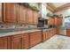 Gourmet kitchen featuring granite countertops, stainless appliances, and custom wood cabinets for storage at 761 Romano Ln, Henderson, NV 89012