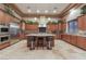 Gourmet kitchen featuring stainless appliances, custom cabinets, granite counters, and a center island with seating at 761 Romano Ln, Henderson, NV 89012
