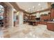 A spacious kitchen features a large island, stainless steel appliances, and custom cabinets with overhead plants at 761 Romano Ln, Henderson, NV 89012