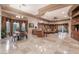Expansive living area with tile flooring, natural light, and a bar area, perfect for entertaining at 761 Romano Ln, Henderson, NV 89012