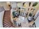 Spacious living room with high ceilings, large windows, and elegant staircase at 761 Romano Ln, Henderson, NV 89012