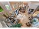Bright, airy living room with two-story ceilings, numerous windows, and stone tile flooring at 761 Romano Ln, Henderson, NV 89012