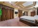 Spacious main bedroom featuring a fireplace, large windows, and a decorative coffered ceiling at 761 Romano Ln, Henderson, NV 89012