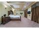 Main bedroom featuring tray ceilings, recessed lighting, and views of the backyard at 761 Romano Ln, Henderson, NV 89012