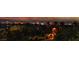 Beautiful night view of the Las Vegas strip from a luxury property with mature landscaping in the foreground at 761 Romano Ln, Henderson, NV 89012