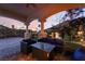Comfortable outdoor seating area under a covered patio, perfect for relaxing and enjoying the sunset views at 761 Romano Ln, Henderson, NV 89012