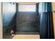 Modern shower with black marble tile and a small window that brings in natural light at 761 Romano Ln, Henderson, NV 89012