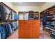 Organized walk-in closet with custom shelving, drawers, and hanging space at 761 Romano Ln, Henderson, NV 89012