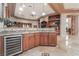 Spacious wet bar features stainless appliances, custom cabinets and stone countertops perfect for entertaining at 761 Romano Ln, Henderson, NV 89012