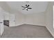 Bright bedroom with neutral carpet, white walls, ceiling fan and an open doorway at 8379 Drop Camp St, Las Vegas, NV 89123