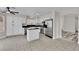 Open kitchen with stainless appliances, granite countertops, large island and easy access to dining at 8379 Drop Camp St, Las Vegas, NV 89123