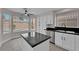 Bright kitchen features granite counters, stainless appliances, and a center island, plus a view of the pool at 8379 Drop Camp St, Las Vegas, NV 89123