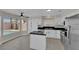 Bright kitchen features granite counters, stainless appliances, and a center island, plus a view of the pool at 8379 Drop Camp St, Las Vegas, NV 89123