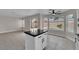 Bright kitchen features granite counters, a center island, and views of the pool through bay windows at 8379 Drop Camp St, Las Vegas, NV 89123