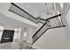 Bright view of open staircase with black railings leading to upper level and view of modern fireplace at 8379 Drop Camp St, Las Vegas, NV 89123